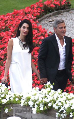 Amal Alamuddin in a white mini dress with fiance George Clooney in Italy.jpg